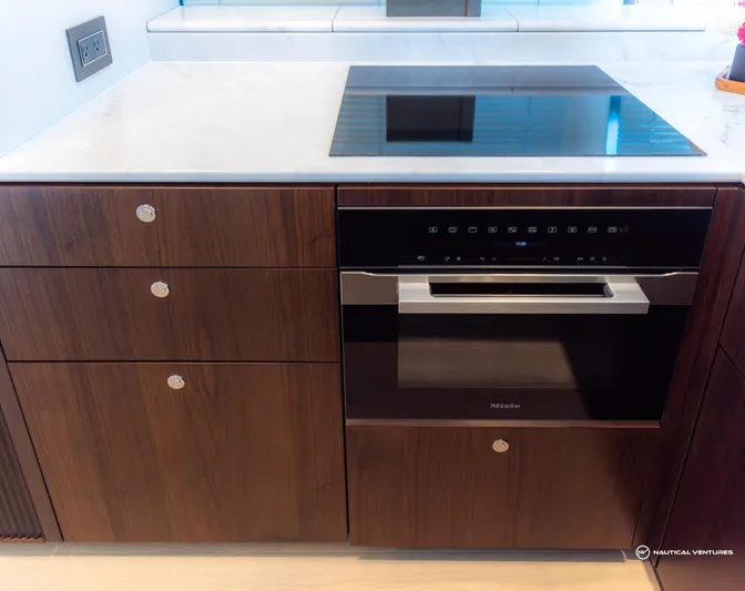 Fairline Phantom Yacht Photos Pics Modern kitchen in 2023 Fairline Phantom 65 yacht with sleek cabinetry and built-in appliances.