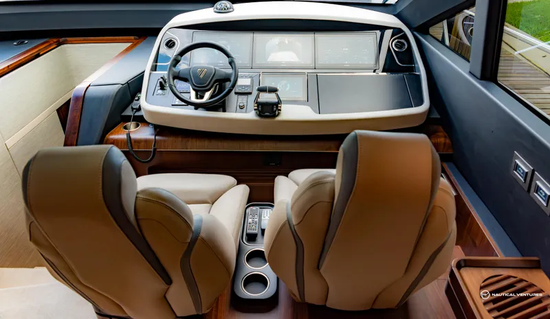 Fairline Phantom Yacht Photos Pics 2023 Fairline Phantom 65 yacht cockpit with modern controls and luxurious seating.