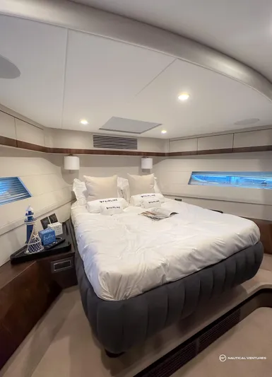 Fairline Phantom Yacht Photos Pics Luxurious bedroom in 2023 Fairline Phantom 65 yacht with modern design and cozy bedding.