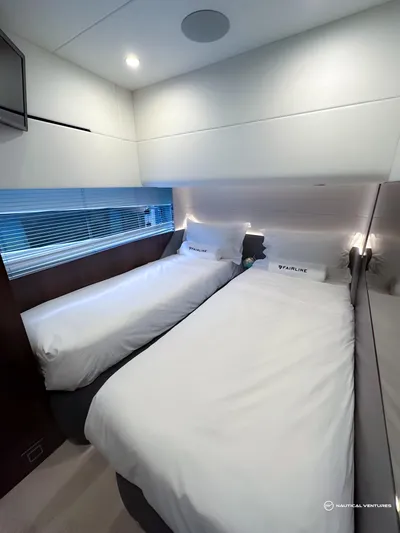 Fairline Phantom Yacht Photos Pics 2023 Fairline Phantom 65 cabin with twin beds, modern design, and ambient lighting.