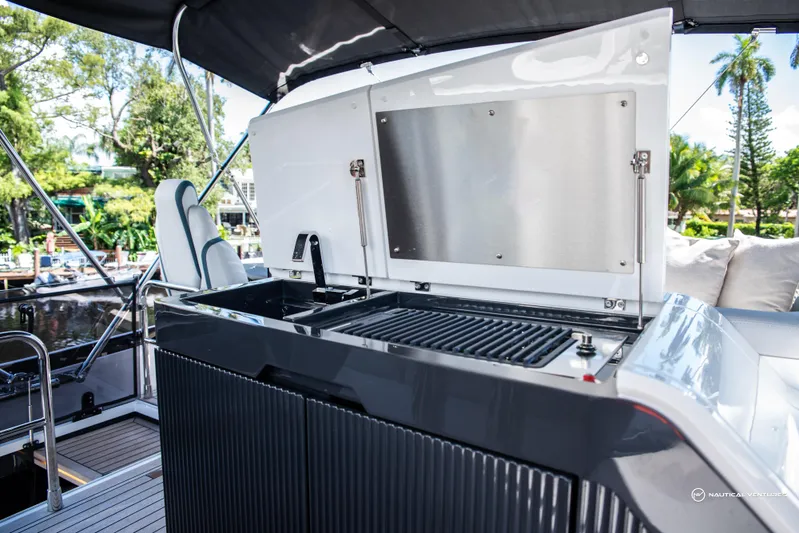 Fairline Phantom Yacht Photos Pics Outdoor kitchen on 2023 Fairline Phantom 65 yacht with grill and seating area.