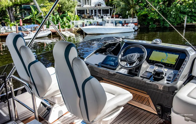 Fairline Phantom Yacht Photos Pics 2023 Fairline Phantom 65 yacht cockpit with modern navigation system and luxurious seating.