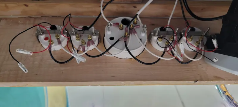 Patience Yacht Photos Pics Electrical wiring setup with multiple connections on a wooden board, Custom M27, 2023.