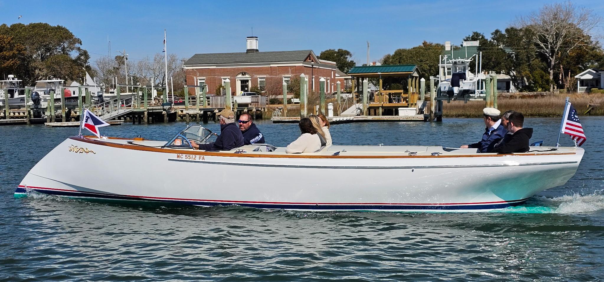 Custom M27 boat cruising on a calm waterway, 2023 model.