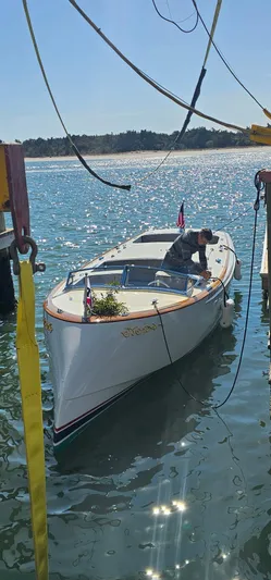 Patience Yacht Photos Pics Custom M27 boat on water, 2023 model, with person onboard under sunny sky.