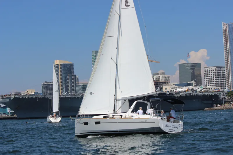 Silver Lining Yacht Photos Pics 2015 Beneteau Oceanis 35 sailboat on water with city skyline.