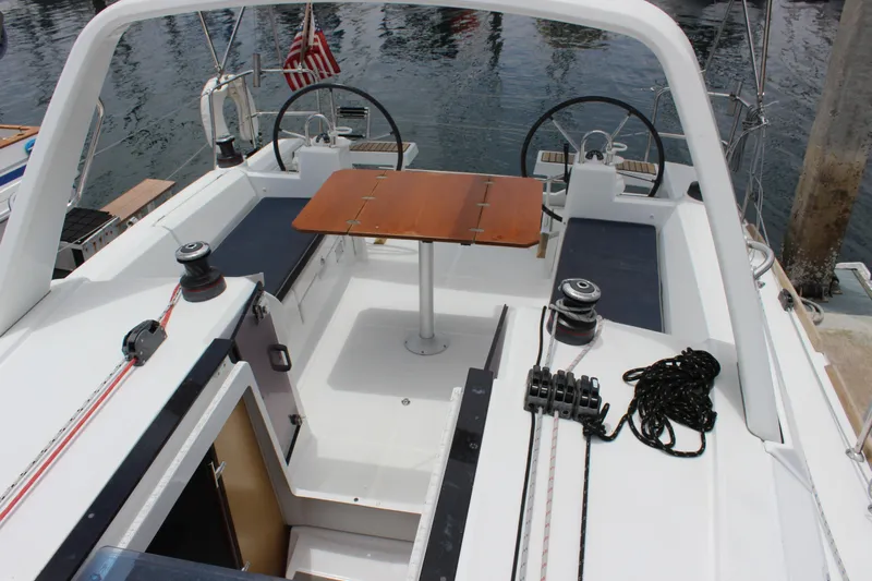 Silver Lining Yacht Photos Pics Cockpit of 2015 Beneteau Oceanis 35 yacht with table and steering wheels.