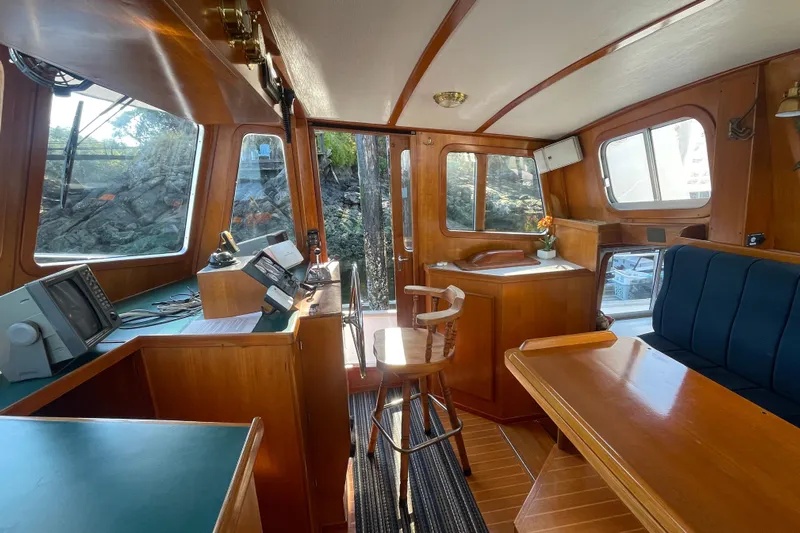 Honu Yacht Photos Pics Interior of 1994 Eagle 40 Pilothouse Trawler with wooden furnishings and navigation equipment.