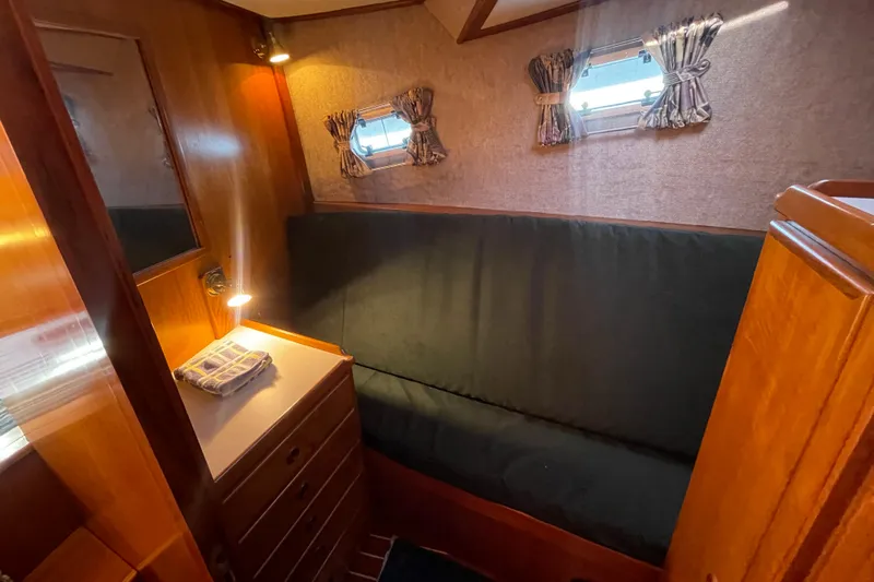 Honu Yacht Photos Pics Cozy cabin interior of 1994 Eagle 40 Pilothouse Trawler with wood finish and soft lighting.