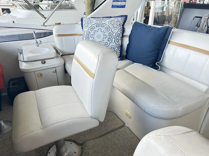 Miracles Yacht Photos Pics Interior of 2006 Carver 41 Cockpit Motor Yacht with white seating and decorative pillows.
