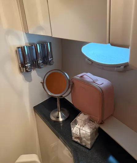 Miracles Yacht Photos Pics Bathroom vanity area in a 2006 Carver 41 Cockpit Motor Yacht with mirror and toiletries.