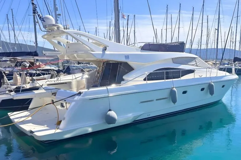 M/y Kosmos II Yacht Photos Pics Luxury 2006 Ferretti 530 yacht docked in a marina, surrounded by sailboats.