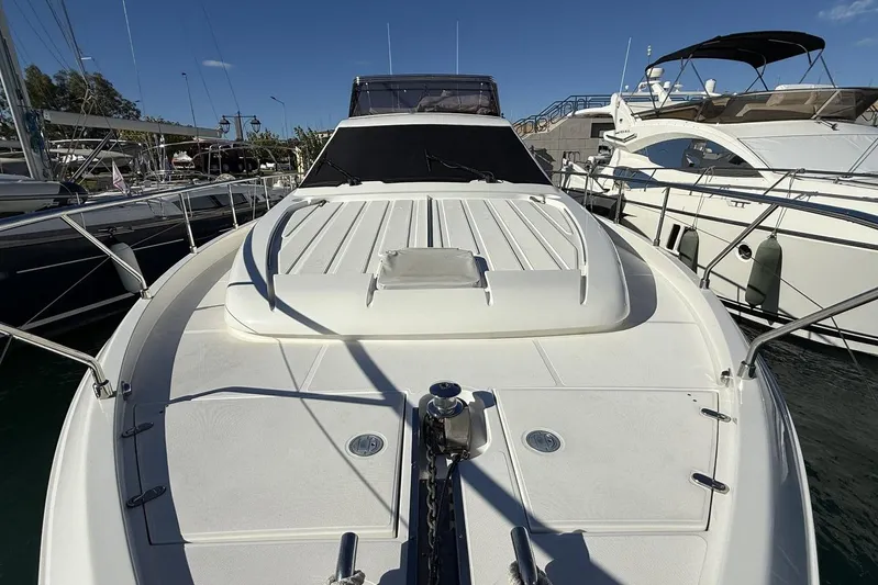 M/y Kosmos II Yacht Photos Pics 2006 Ferretti 530 yacht docked at marina, showcasing sleek design and spacious deck.