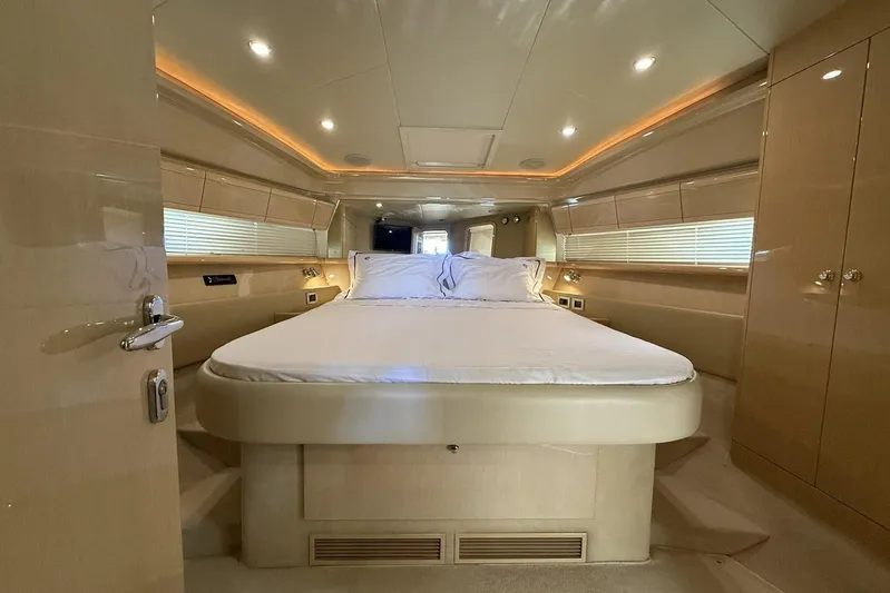 M/y Kosmos II Yacht Photos Pics Luxurious bedroom interior of a 2006 Ferretti 530 yacht, featuring elegant lighting and modern design.