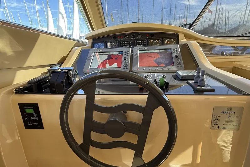 M/y Kosmos II Yacht Photos Pics Helm of 2006 Ferretti 530 yacht with navigation screens and controls.