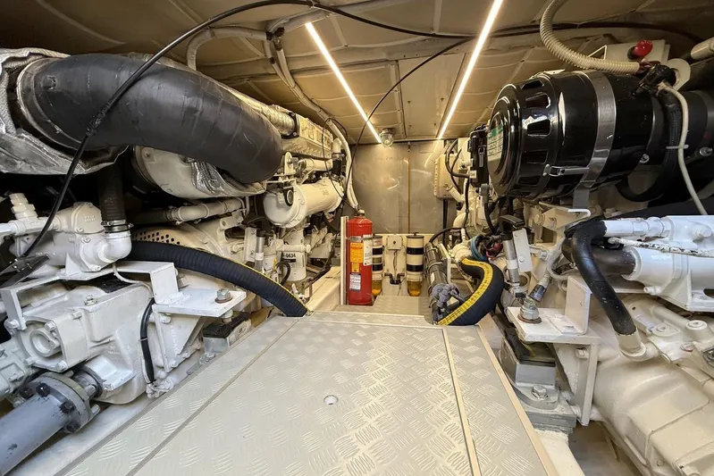 M/y Kosmos II Yacht Photos Pics Engine room of a 2006 Ferretti 530 yacht, featuring mechanical components and fire extinguisher.