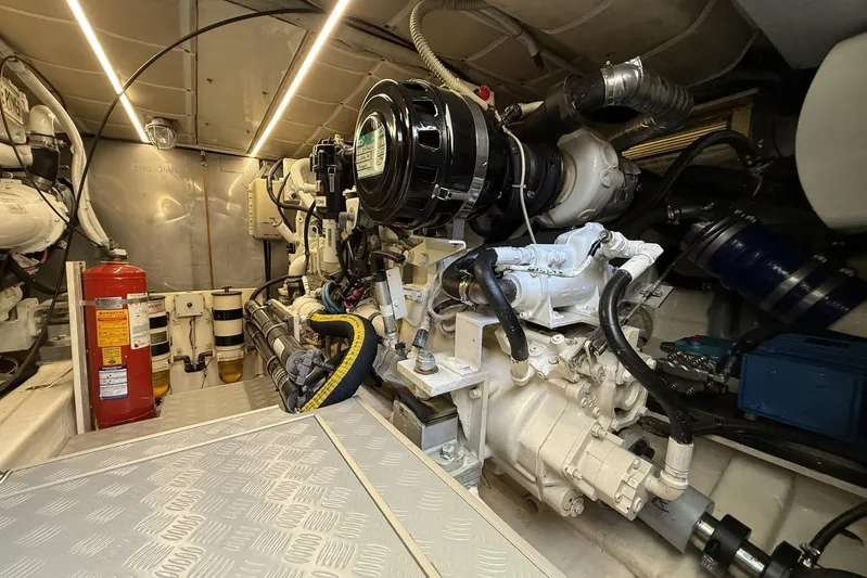 M/y Kosmos II Yacht Photos Pics Engine room of a 2006 Ferretti 530 yacht, featuring mechanical components and fire extinguisher.