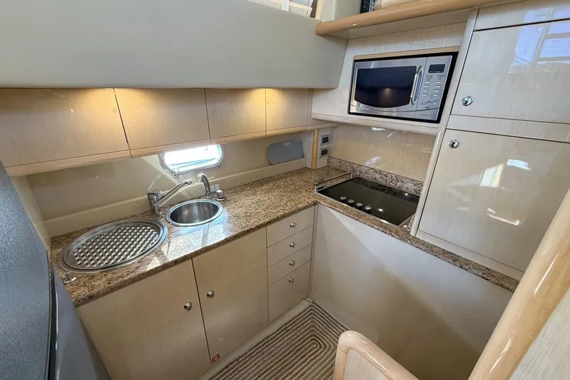 M/y Kosmos II Yacht Photos Pics Luxurious 2006 Ferretti 530 yacht kitchen with modern appliances and sleek design.