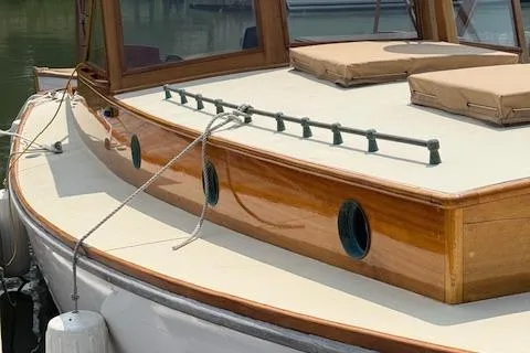 Ilona Yacht Photos Pics Custom Gannon & Benjamin 2005 boat with wooden deck and portholes, docked in marina.