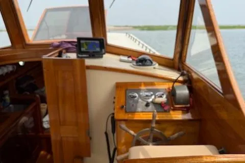 Ilona Yacht Photos Pics Wooden boat interior with steering wheel, navigation equipment, and control panel, Custom Gannon & Benjamin, 2005.