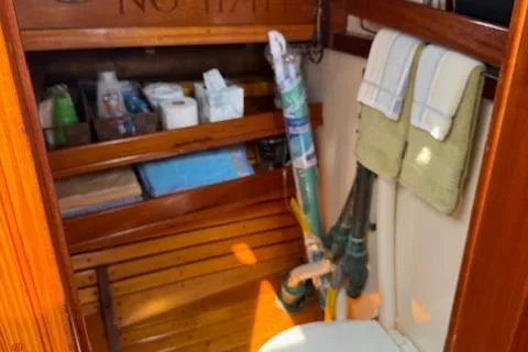 Ilona Yacht Photos Pics Wooden boat interior with storage shelves, towels, and a toilet; Gannon & Benjamin, 2005.