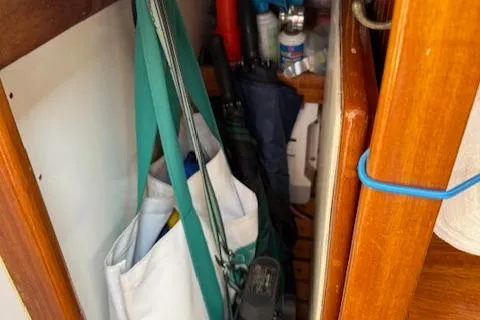 Ilona Yacht Photos Pics Storage area on a 2005 Custom Gannon & Benjamin boat with various items and wooden interior.