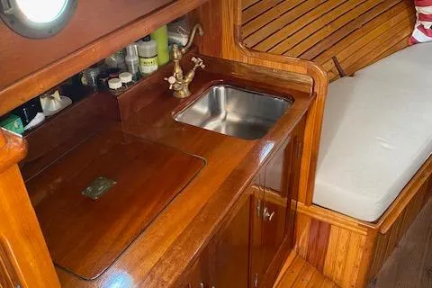 Ilona Yacht Photos Pics Custom Gannon & Benjamin 2005 boat interior with wooden cabinetry and compact sink.