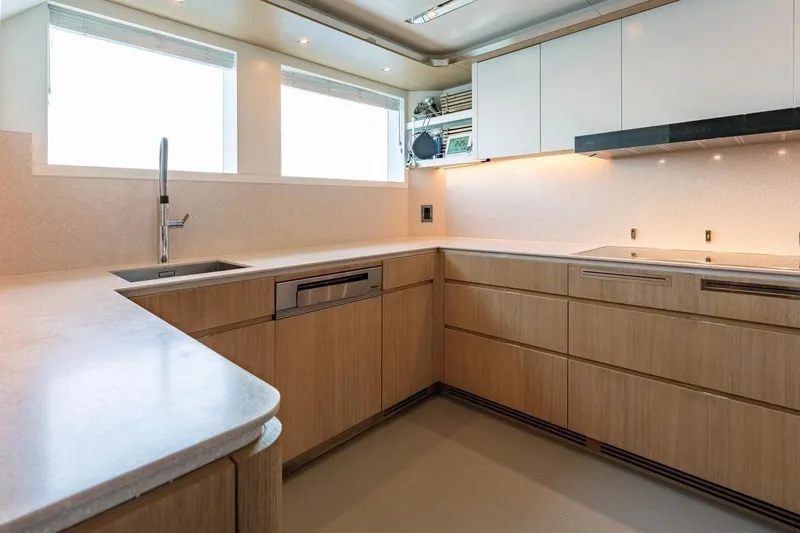Kokoro Yacht Photos Pics Modern kitchen interior on Moonen Martinique YN1 yacht, 2020 model, featuring sleek cabinetry and fixtures.