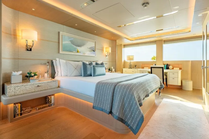 Kokoro Yacht Photos Pics Luxurious bedroom interior on 2020 Moonen Martinique YN1 yacht, featuring elegant decor and ample natural light.