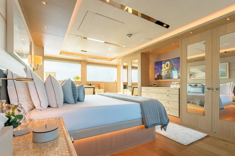 Kokoro Yacht Photos Pics Luxurious bedroom interior of 2020 Moonen Martinique YN1 yacht with elegant decor and ambient lighting.