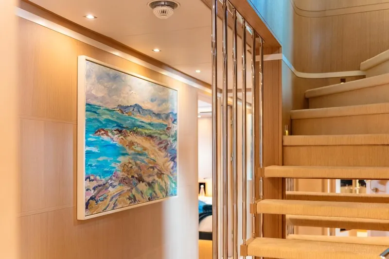 Kokoro Yacht Photos Pics Interior of 2020 Moonen Martinique YN1 yacht with staircase and vibrant seascape painting.