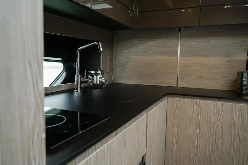  Yacht Photos Pics Modern kitchen interior of 2024 Azimut Atlantis 45 yacht, featuring sleek design and fixtures.