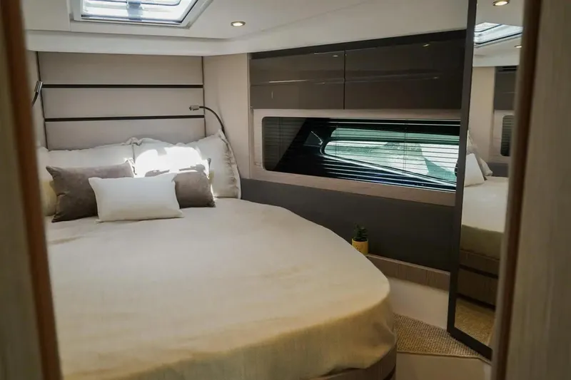  Yacht Photos Pics Luxurious bedroom interior of 2024 Azimut Atlantis 45 yacht with modern design.