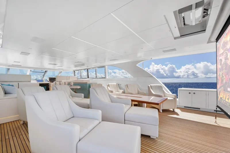 Miss Michelle Yacht Photos Pics Luxurious Horizon 122RP yacht interior with white seating, ocean view, and entertainment screen, 2025 model.