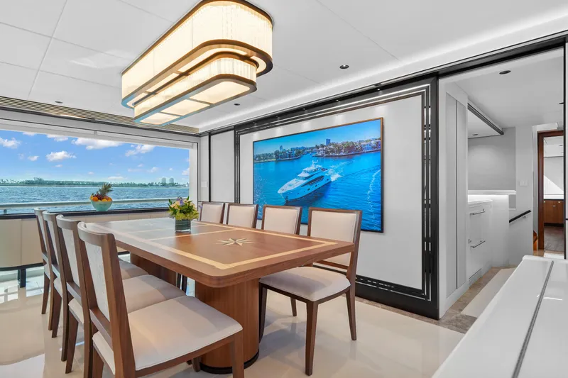 Miss Michelle Yacht Photos Pics Luxurious dining area on 2025 Horizon 122RP yacht with ocean view and elegant decor.