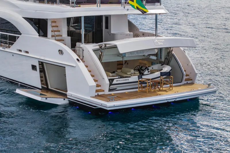 Miss Michelle Yacht Photos Pics Luxury Horizon 122RP yacht, 2025 model, with open deck and tender boat on water.