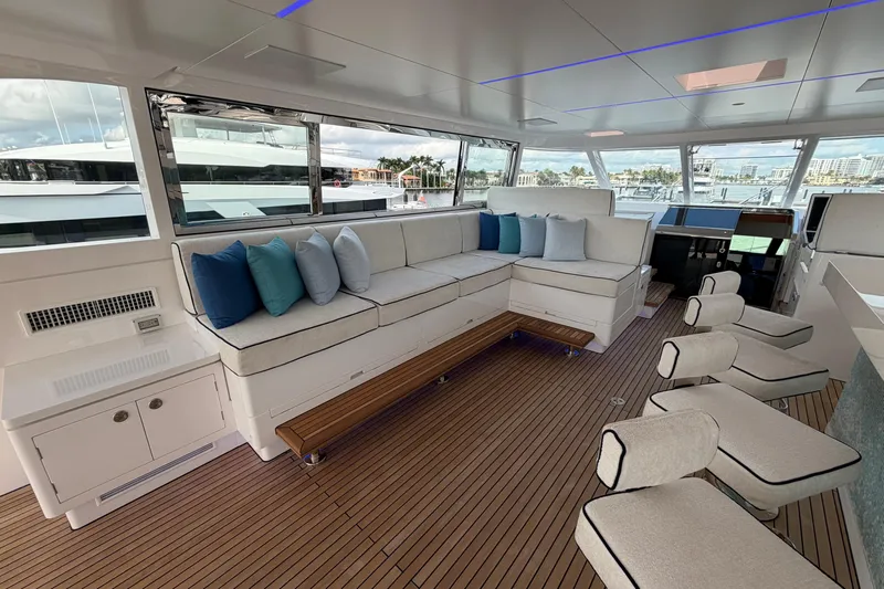 Miss Michelle Yacht Photos Pics Luxurious interior of 2025 Horizon 122RP yacht with plush seating and panoramic windows.