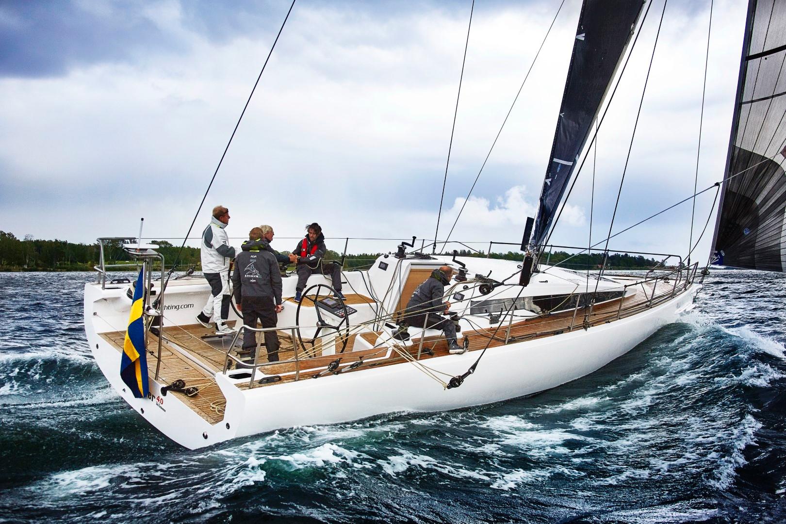 Sailing on a 2024 Shogun 50 yacht with crew on deck in choppy waters.