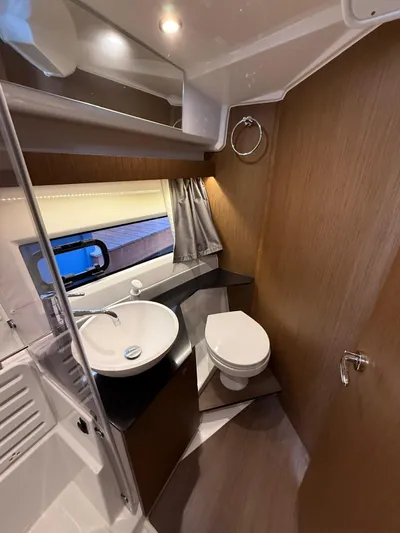  Yacht Photos Pics 2021 Jeanneau NC Weekender 1095 bathroom with modern fixtures and wood accents.
