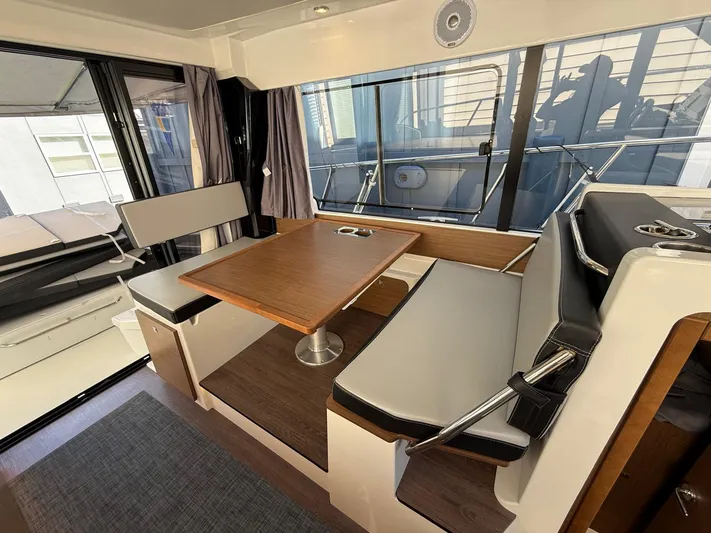  Yacht Photos Pics Interior of 2021 Jeanneau NC Weekender 1095 with dining area and seating.