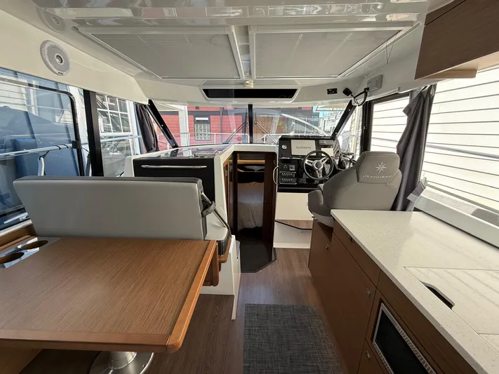  Yacht Photos Pics Interior of 2021 Jeanneau NC Weekender 1095, featuring helm, seating, and modern amenities.