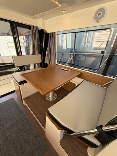  Yacht Photos Pics Interior of 2021 Jeanneau NC Weekender 1095 with dining area and large windows.
