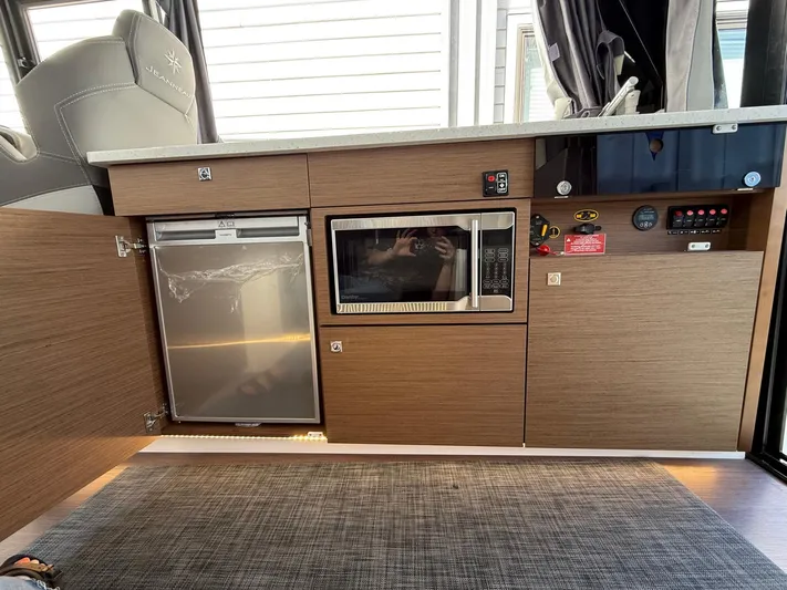  Yacht Photos Pics Interior of 2021 Jeanneau NC Weekender 1095 showing kitchen appliances and cabinetry.