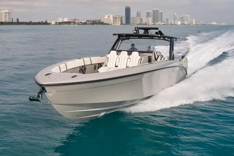 Ghost Yacht Photos Pics 2021 Midnight Express 43 Open boat cruising on blue water near city skyline.