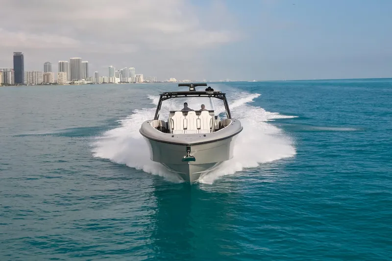 Ghost Yacht Photos Pics 2021 Midnight Express 43 Open boat cruising on blue ocean near city skyline.