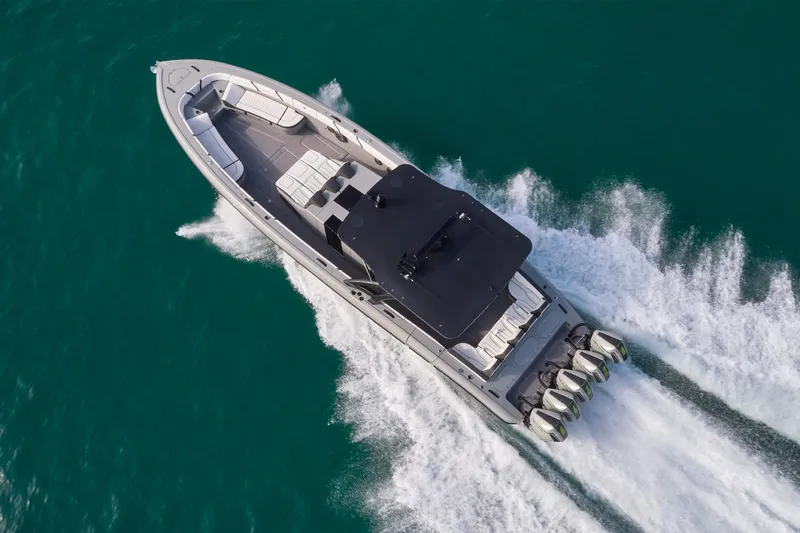 Ghost Yacht Photos Pics Aerial view of 2021 Midnight Express 43 Open boat speeding on turquoise water.