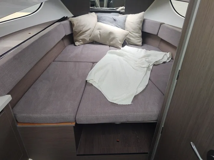 Paul's Legacy Yacht Photos Pics 2023 Beneteau Flyer 9 SUNdeck cabin interior with cozy bedding and cushions.