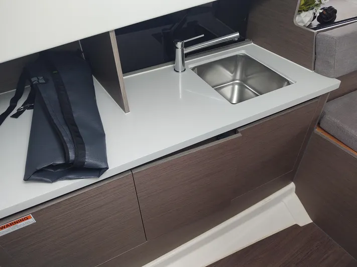 Paul's Legacy Yacht Photos Pics 2023 Beneteau Flyer 9 SUNdeck interior with modern kitchenette and sink.