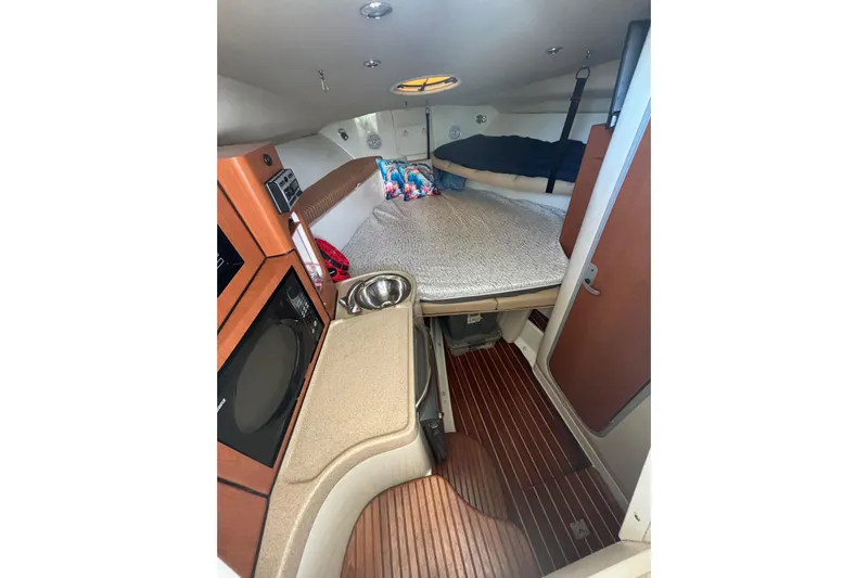  Yacht Photos Pics 2006 Hydra-Sports Vector 2900 VX cabin interior with kitchenette and sleeping area.