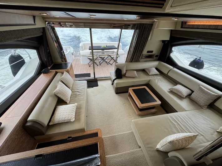 Miss Understood Yacht Photos Pics Luxurious interior of 2015 Azimut 64 yacht with elegant seating and ocean view.